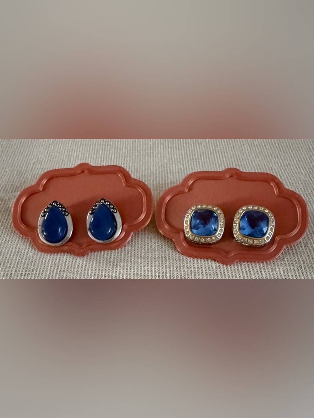 Two pair stud earrings with blue stones.